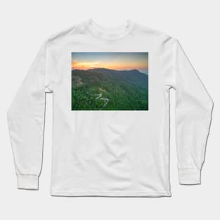 Aerial view of curvy mountain road through a jungle ay sunset Long Sleeve T-Shirt